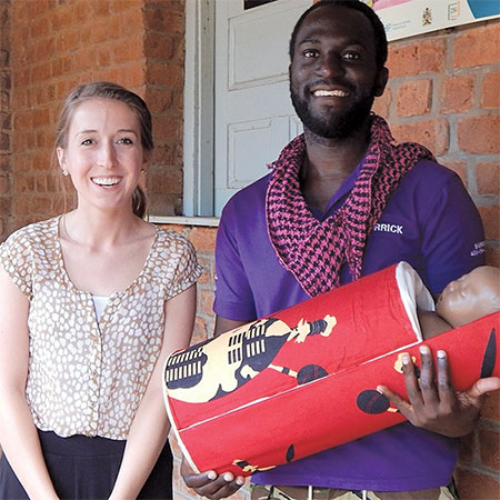 Virginia Tech doctoral student Ashley Taylor with Malawi native holding a baby pod