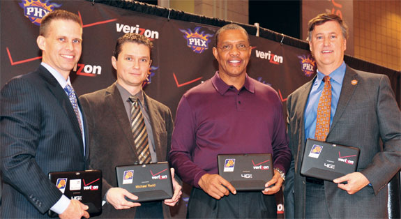 Brad Casper '82 (right), pictured with Alvin Gentry, the Phoenix Sun's head coach (second from right), and others, oversees business and non-basketball operations for the franchise. Courtesy of Barry Gossage, NBA Photos.