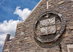 Formerly adorning Shultz Hall, a medallion featuring the university seal has been installed on an exterior wall of the Holtzman Alumni Center. Photo by Dave Hunt.