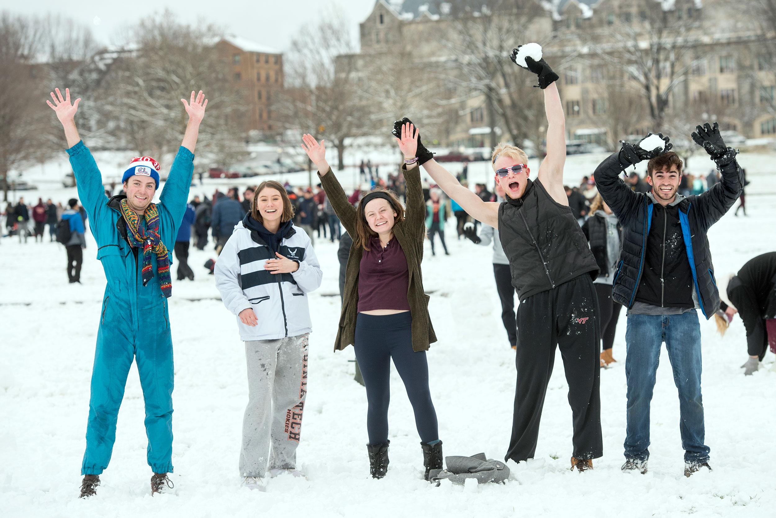 Students playing in the snow on the Drillfield.