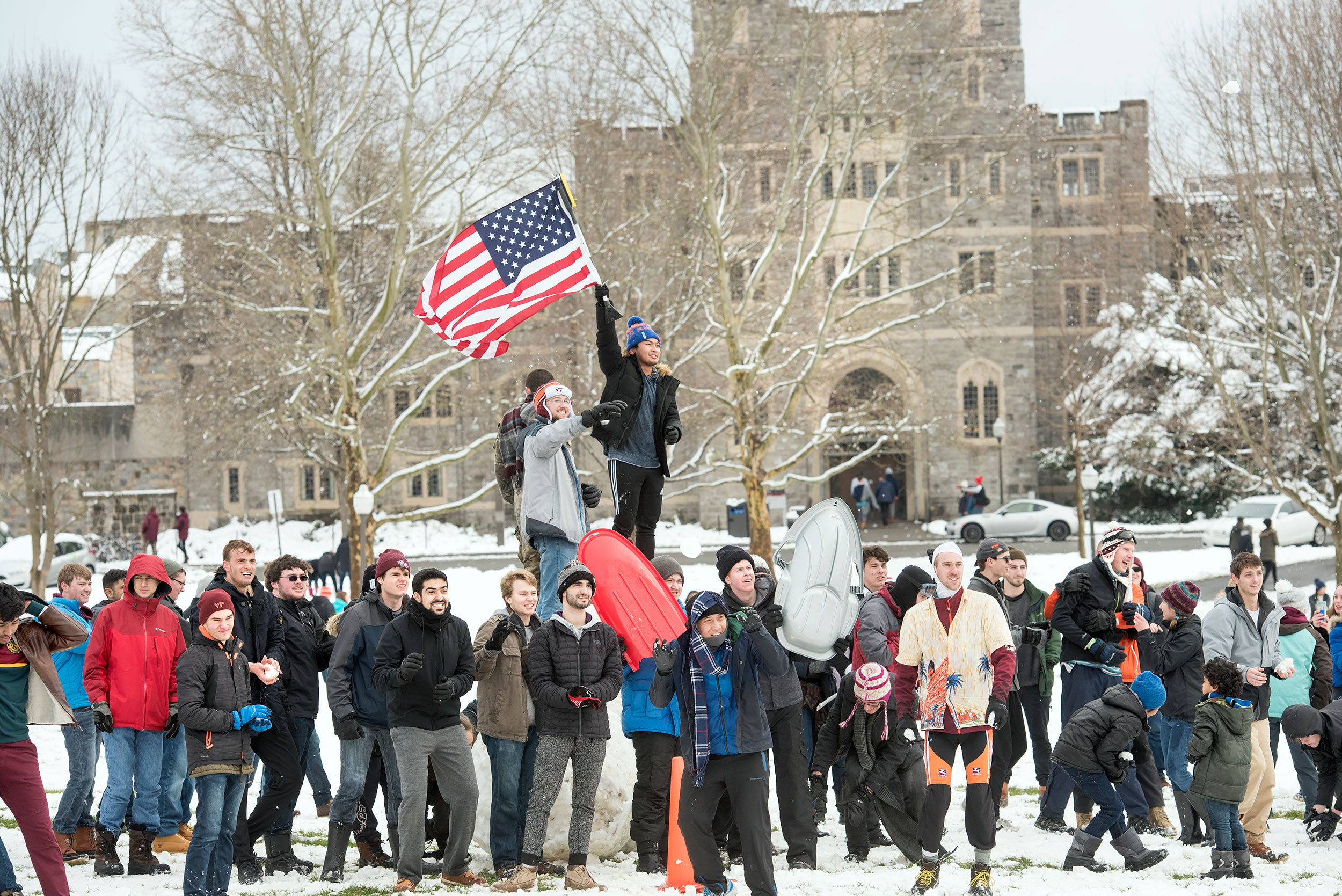 Students playing in the snow on the Drillfield.