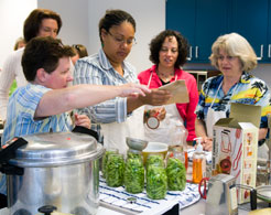 Responding to renewed interest in food preservation, Extension implemented new programs for homeowners. Here, agents learn about canning techniques.