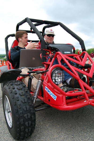 Greg Jannaman (left) with Patrick Johnson, a graduate student in special education administration, behind the wheel. Jannaman was part of a student team that developed a vehicle for the Blind Driver Challenge.