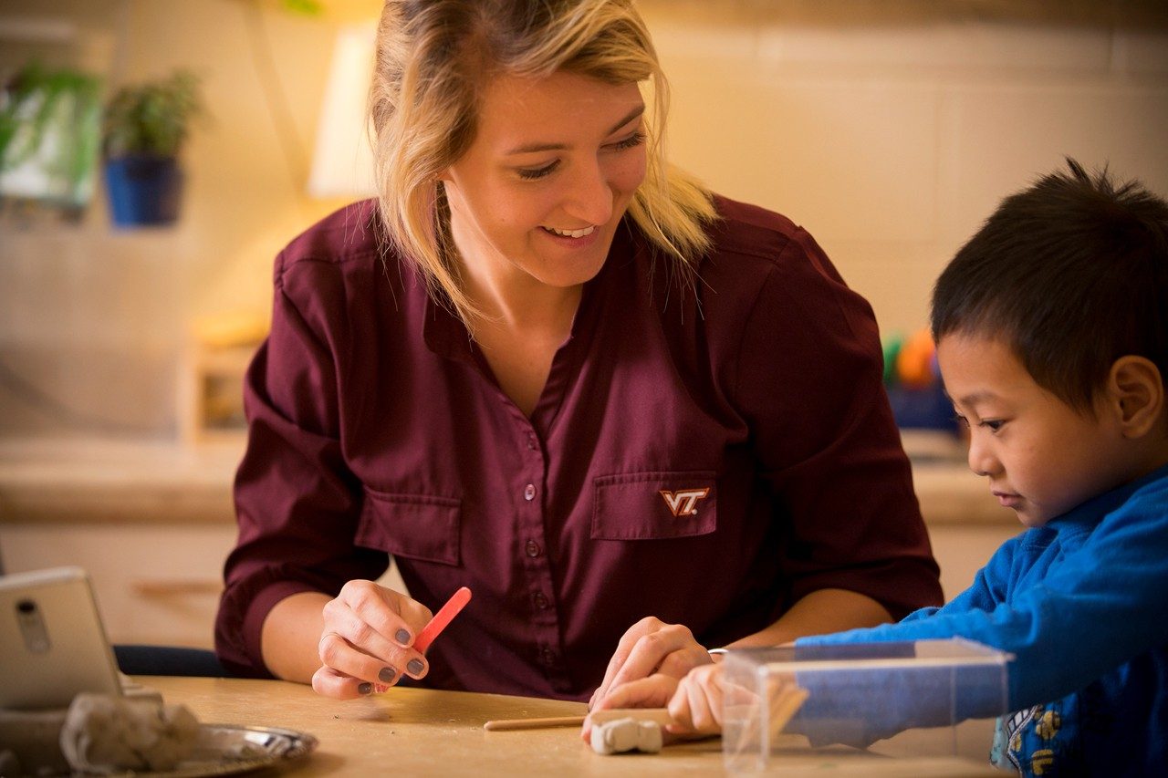 Virginia Tech alumna Emily Phillips works with a child