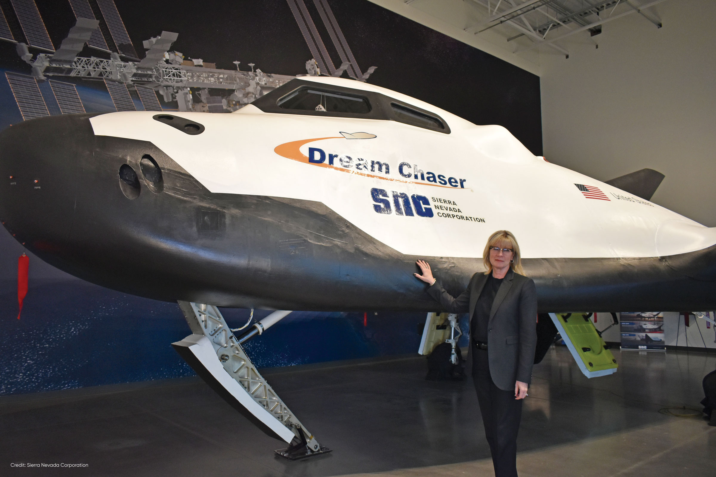 Pat Remias stands before the Dream Chaser
